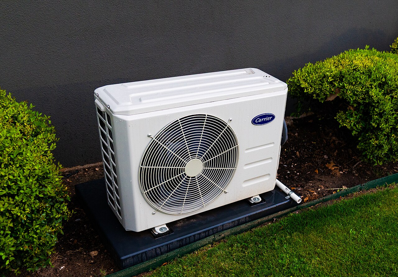Carrier outdoor heat pump unit installed beside a home