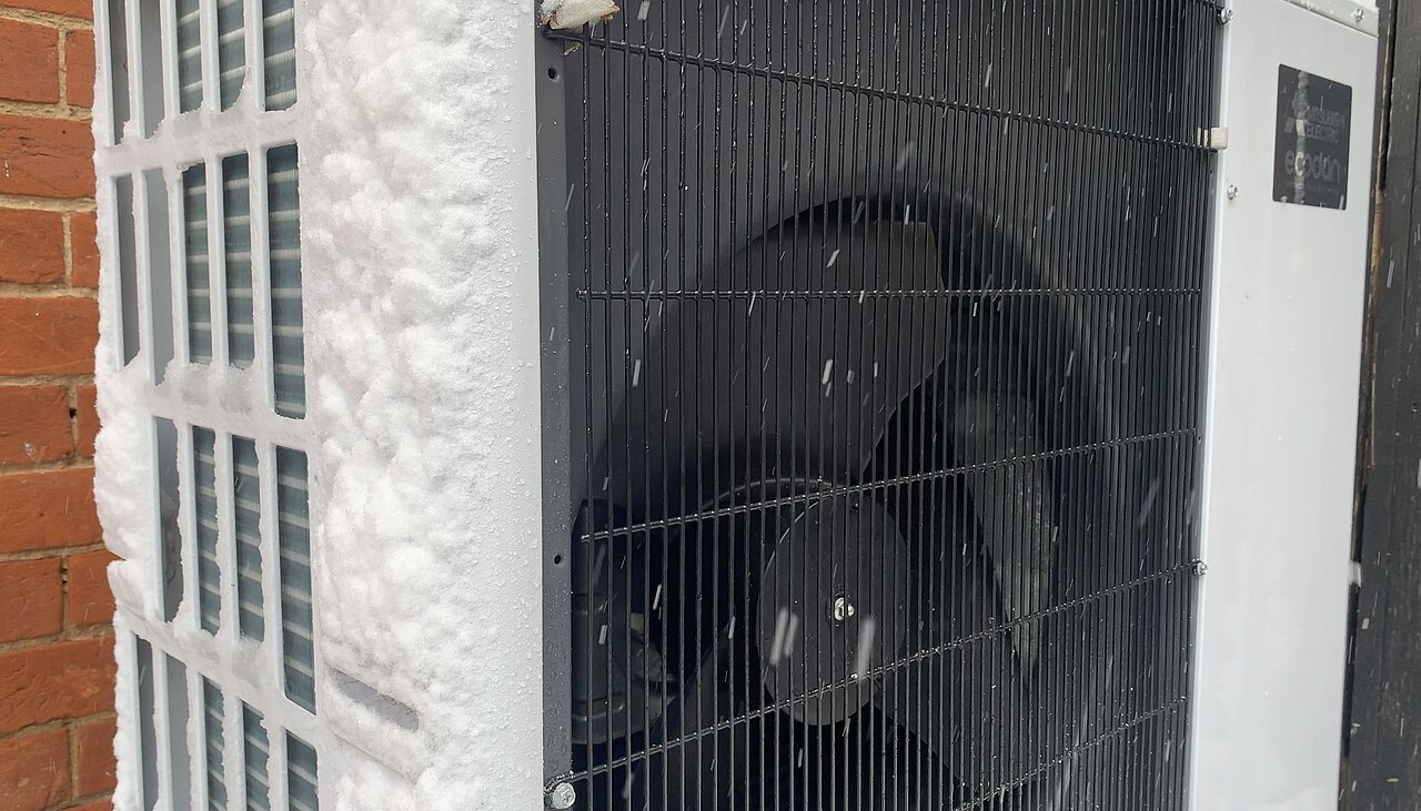 Outdoor heat pump unit running in winter snow